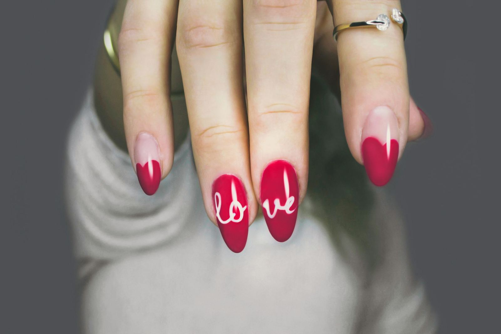 Pink nails hand-painted with the word love