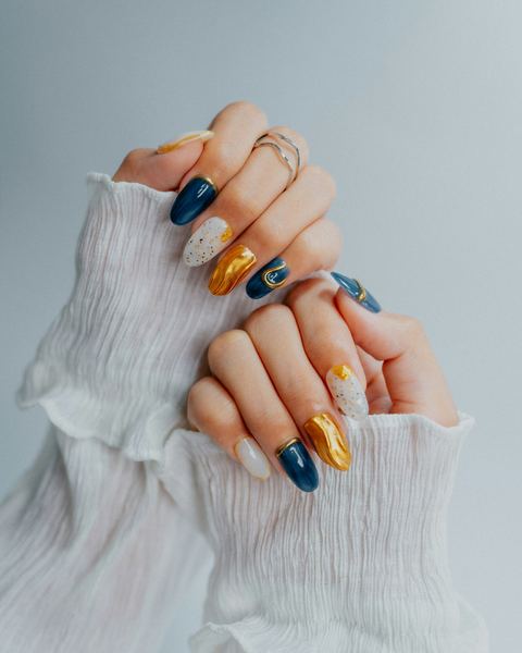 Navy, gold and white nail art on almond nails