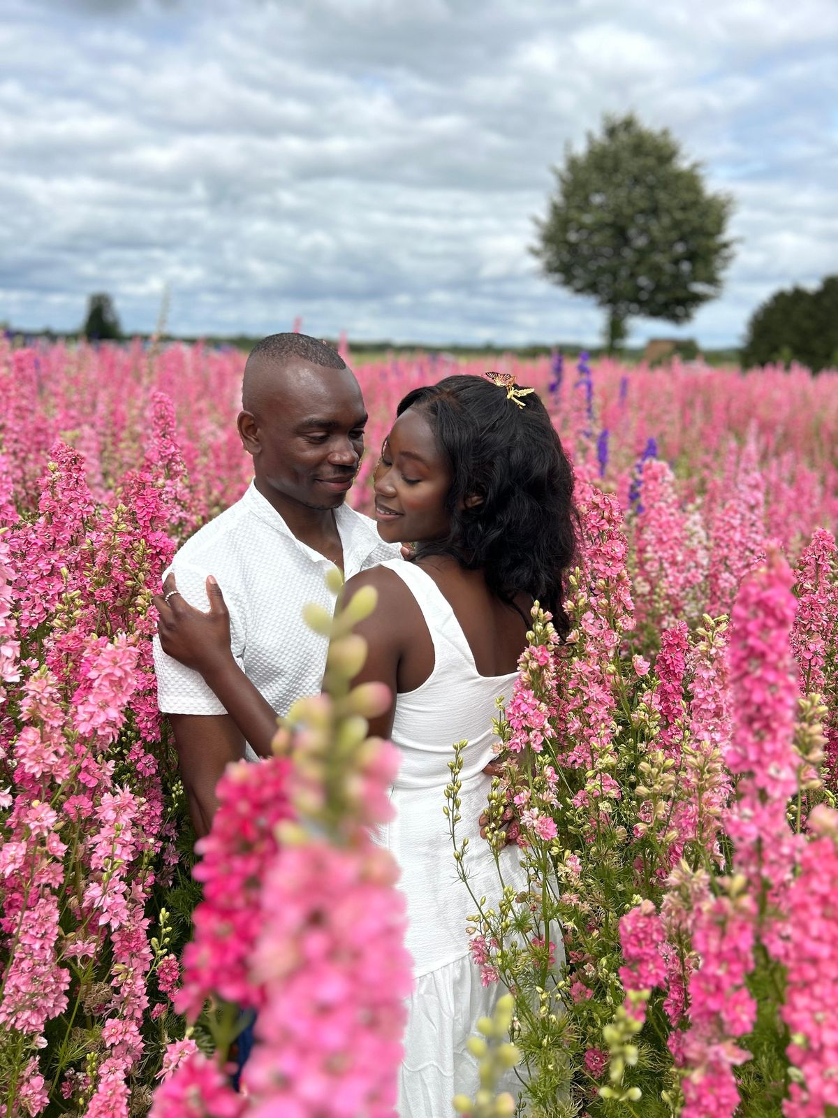 Davidson and Makanaka in a field of pink flowers