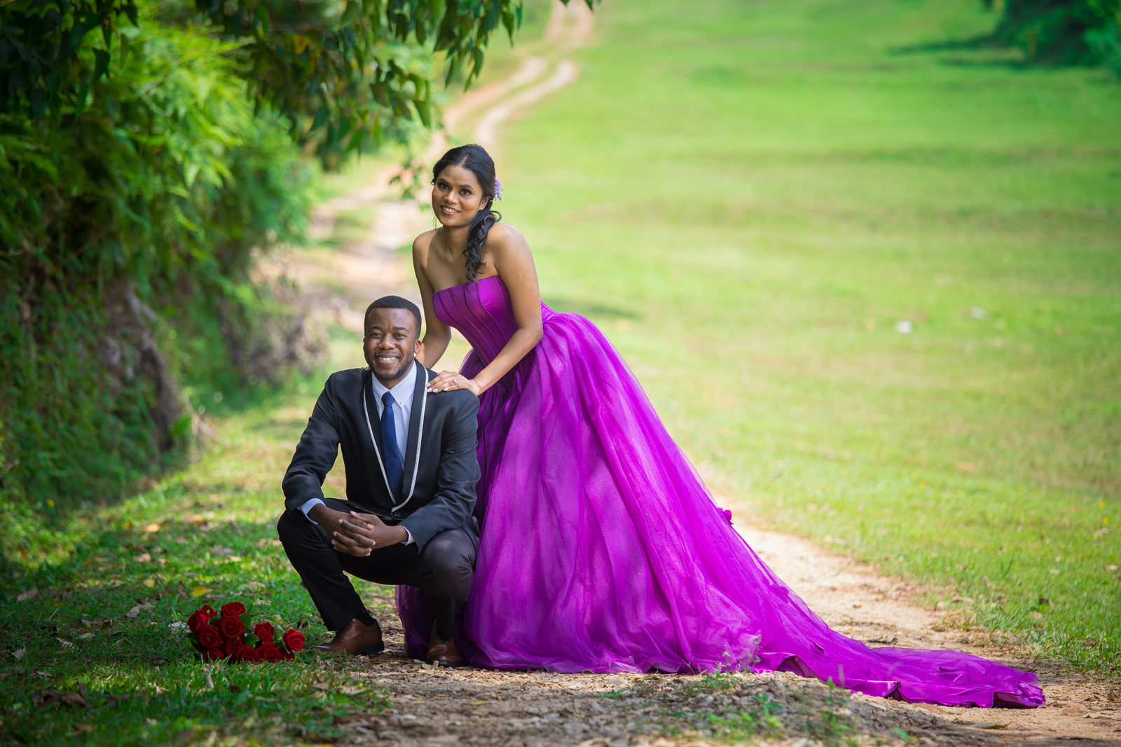 The couple on a grassy park path, Aghalya in a flowing magenta gown