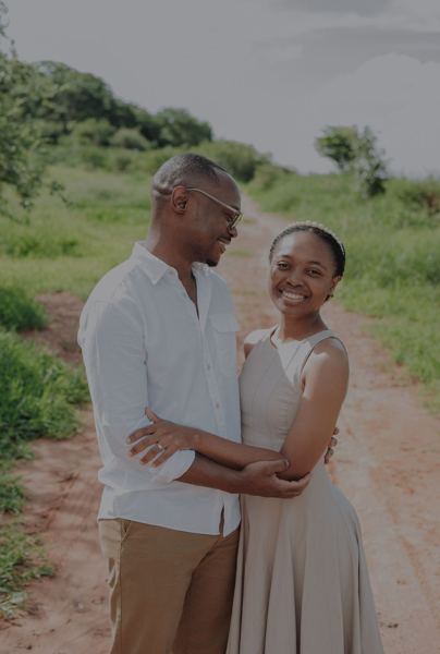 A warm hug, both smiling at the camera