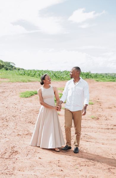 Standing together in a field under a wide sky
