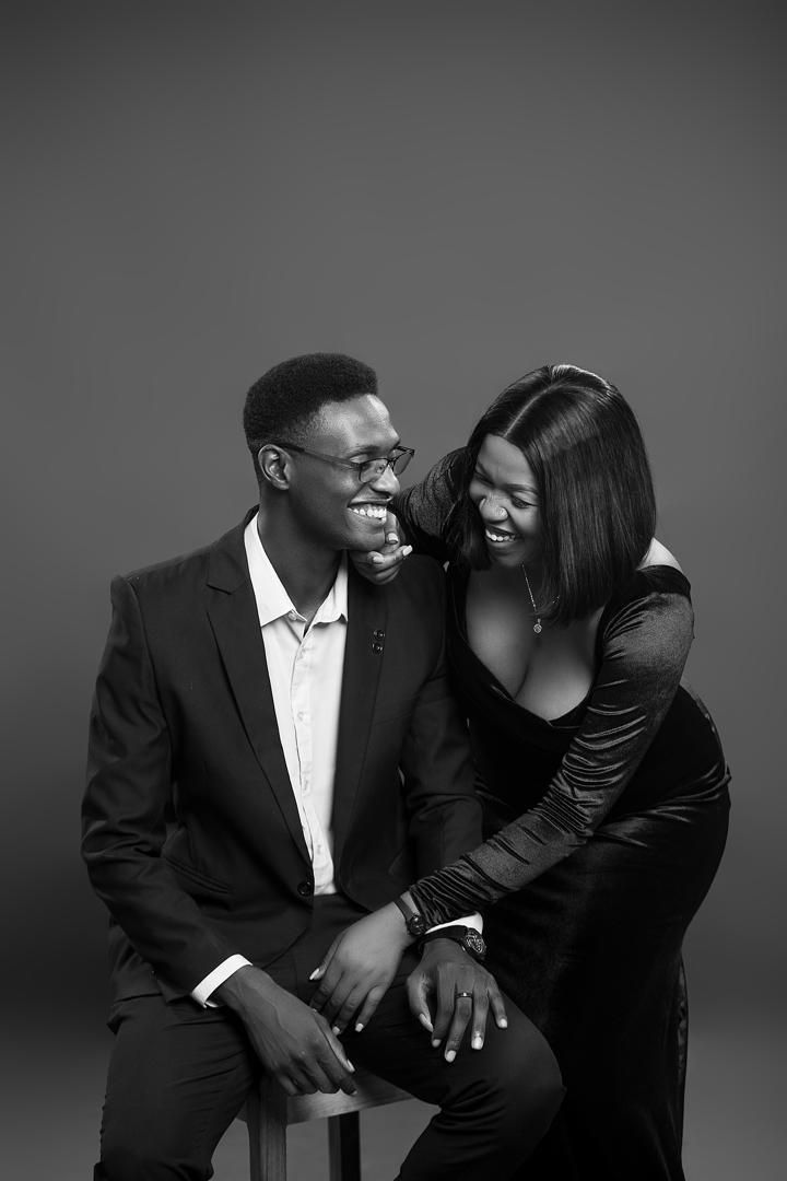 A black-and-white photo of Elijah and Mwaka laughing together