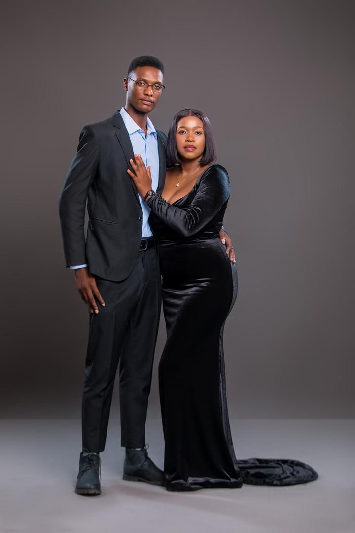 Elijah and Mwaka standing side by side, her hand on his chest