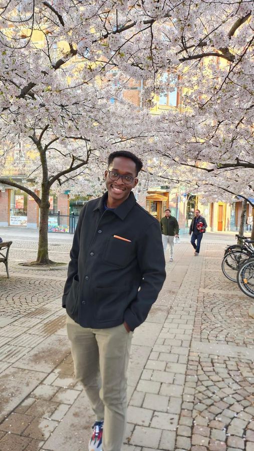 Mpaala smiling under cherry blossom